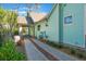 Exterior view of the light blue home featuring driveway and lush landscaping at 1612 E Washington St, Orlando, FL 32803