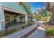 Exterior side view of home featuring the covered patio, fire pit and driveway at 1612 E Washington St, Orlando, FL 32803