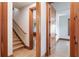 Hallway and staircase featuring wood trim, and access to rooms with windows and hardwood flooring at 1612 E Washington St, Orlando, FL 32803