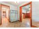Hallway with coat rack and access to room with wood paneling and decorative hardwood flooring at 1612 E Washington St, Orlando, FL 32803