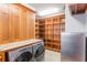 Laundry room with wood cabinetry, granite counters, stainless appliances, and lots of storage space at 1612 E Washington St, Orlando, FL 32803