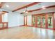 Bright living room with wood beam ceilings and seamless indoor-outdoor transition at 1612 E Washington St, Orlando, FL 32803