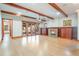 Large living room with wood beams, a fireplace, and access to the backyard at 1612 E Washington St, Orlando, FL 32803