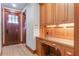 Home office features custom wood built-ins with storage cabinets and drawers, with a door to the front entrance at 1612 E Washington St, Orlando, FL 32803