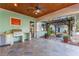 Covered outdoor kitchen with built in stainless grill, wood ceiling and fire pit at 1612 E Washington St, Orlando, FL 32803