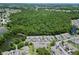 Aerial view of the condo community with nearby pond and surrounded by lush forest at 2040 Royal Bay Blvd # 30, Kissimmee, FL 34746