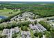 Aerial view of the property showing a well-maintained community, mature trees and a lake nearby at 2040 Royal Bay Blvd # 30, Kissimmee, FL 34746