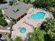 Aerial of a clubhouse featuring pool, hot tub, sun deck, and inviting outdoor lounge area for residents at 2040 Royal Bay Blvd # 30, Kissimmee, FL 34746
