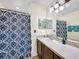Bright bathroom with a vanity, mirror, and shower with a decorative curtain at 2040 Royal Bay Blvd # 30, Kissimmee, FL 34746