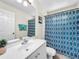 Bathroom featuring a single sink vanity with a blue shower curtain and tile floors at 2040 Royal Bay Blvd # 30, Kissimmee, FL 34746