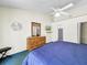 Comfortable bedroom featuring a ceiling fan and a dresser with a stylish mirror at 2040 Royal Bay Blvd # 30, Kissimmee, FL 34746