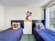 Bright bedroom featuring twin beds, a playful Mickey Mouse theme, and natural light from the window at 2040 Royal Bay Blvd # 30, Kissimmee, FL 34746