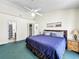 Cozy bedroom with a ceiling fan, comfortable bed, and side tables with lamps at 2040 Royal Bay Blvd # 30, Kissimmee, FL 34746