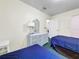 Bright bedroom with twin beds and a white dresser at 2040 Royal Bay Blvd # 30, Kissimmee, FL 34746