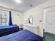 Bright bedroom with twin beds, white wicker dresser, and an open doorway at 2040 Royal Bay Blvd # 30, Kissimmee, FL 34746