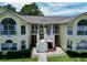 Inviting yellow condo building with white trim, staircases to balconies, and well-manicured landscaping at 2040 Royal Bay Blvd # 30, Kissimmee, FL 34746