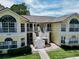Inviting yellow condo building with white trim, staircases to balconies, and well-manicured landscaping at 2040 Royal Bay Blvd # 30, Kissimmee, FL 34746