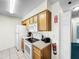 Functional kitchen offering essential appliances, wood cabinets, and a fire extinguisher at 2040 Royal Bay Blvd # 30, Kissimmee, FL 34746