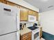 Well-equipped kitchen features appliances, ample counter space, and wood cabinetry at 2040 Royal Bay Blvd # 30, Kissimmee, FL 34746