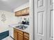 Kitchen view displays the sink, cabinetry, appliances and leads to a peek of the living room at 2040 Royal Bay Blvd # 30, Kissimmee, FL 34746