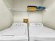 Laundry room with a white washer and dryer, and shelving for storage at 2040 Royal Bay Blvd # 30, Kissimmee, FL 34746