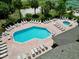 Aerial view of the community pool with plenty of lounge seating, tables, and a hot tub to enjoy a relaxing day in the sun at 2040 Royal Bay Blvd # 30, Kissimmee, FL 34746