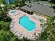 Aerial view of the community pool with plenty of lounge seating, tables, and a hot tub, plus nearby clubhouse at 2040 Royal Bay Blvd # 30, Kissimmee, FL 34746