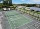 Aerial view of a tennis court with shuffleboard court near a busy street and surrounded by a chain link fence at 2040 Royal Bay Blvd # 30, Kissimmee, FL 34746