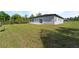 Spacious backyard featuring green lawn and concrete patio, perfect for outdoor enjoyment at 2415 Sw 165Th Pl, Ocala, FL 34473