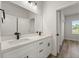Bright bathroom featuring double sinks with black hardware and quartz countertops at 2415 Sw 165Th Pl, Ocala, FL 34473