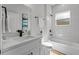 This bathroom showcases a modern vanity with quartz countertop and white tile at 2415 Sw 165Th Pl, Ocala, FL 34473
