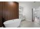 Elegant bathroom with freestanding tub, wood accent wall, and double vanity at 2415 Sw 165Th Pl, Ocala, FL 34473