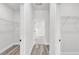 Hallway leading to the Primary bathroom and walk-in closets; featuring wood-look floors at 2415 Sw 165Th Pl, Ocala, FL 34473