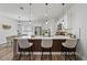 Open kitchen featuring white cabinets, stainless steel appliances, and a breakfast bar with pendant lighting at 2415 Sw 165Th Pl, Ocala, FL 34473