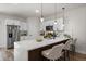 Modern kitchen featuring white cabinets, stainless steel appliances, and a breakfast bar with seating at 2415 Sw 165Th Pl, Ocala, FL 34473