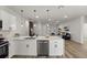Modern white kitchen features stainless steel appliances and breakfast bar that overlooks the living area at 2415 Sw 165Th Pl, Ocala, FL 34473
