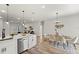 Open-concept kitchen and dining area with stylish pendant lighting and modern décor at 2415 Sw 165Th Pl, Ocala, FL 34473