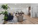 Open-concept living space with hardwood floors, stylish furniture, and a view of the kitchen at 2415 Sw 165Th Pl, Ocala, FL 34473
