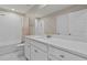 Bathroom featuring a white dual vanity, granite countertops, and shower-tub combo at 2546 Empress Dr, Kissimmee, FL 34741