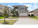 Beautiful two-story home featuring a modern design, two-car garage, and well-maintained lawn at 2546 Empress Dr, Kissimmee, FL 34741