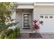 Stylish front door with modern sidelights, complemented by stone accents and lush landscaping at 2546 Empress Dr, Kissimmee, FL 34741