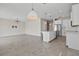 Open-concept kitchen with white cabinets, stainless steel appliances, and a view to the living area at 2546 Empress Dr, Kissimmee, FL 34741