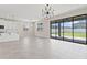 Open-concept living area with tile flooring, modern light fixture, and sliding glass doors to the outdoor space at 2546 Empress Dr, Kissimmee, FL 34741