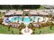 Aerial view of a community pool area with several palm trees, pool furniture, slide, and beautiful landscaping at 2546 Empress Dr, Kissimmee, FL 34741