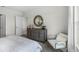 Comfortable bedroom with a dresser, mirror, chair, and soft natural light at 2610 Grandbury Grove Rd, Lakeland, FL 33811