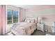 This bedroom is furnished with a beautiful bed and features a large window with natural light at 2610 Grandbury Grove Rd, Lakeland, FL 33811