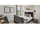 Bedroom with guitar and guitar-themed decor, featuring a modern black bed frame and natural light at 2610 Grandbury Grove Rd, Lakeland, FL 33811