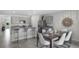 Open kitchen and dining area featuring stainless steel appliances, granite countertops, and stylish furniture at 2610 Grandbury Grove Rd, Lakeland, FL 33811