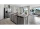 Open kitchen with granite countertops, stainless steel appliances, and a large kitchen island at 2610 Grandbury Grove Rd, Lakeland, FL 33811