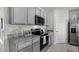 Well-equipped kitchen with stainless steel appliances, granite countertops and ample cabinet space at 2610 Grandbury Grove Rd, Lakeland, FL 33811